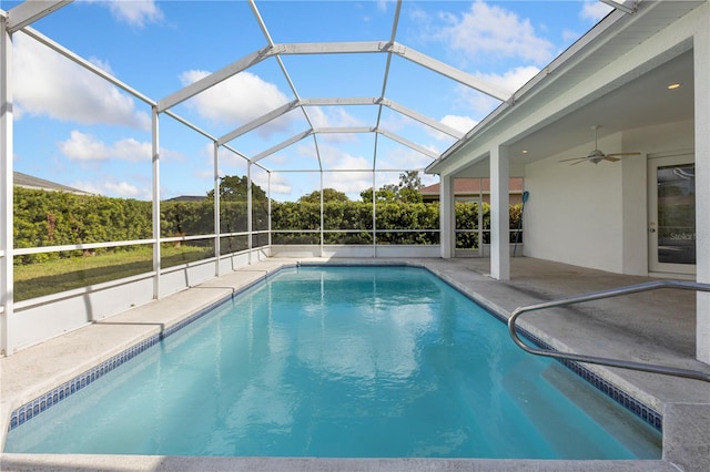 view of swimming pool featuring a lanai, a patio area, and ceiling fan