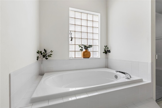 bathroom featuring tiled tub