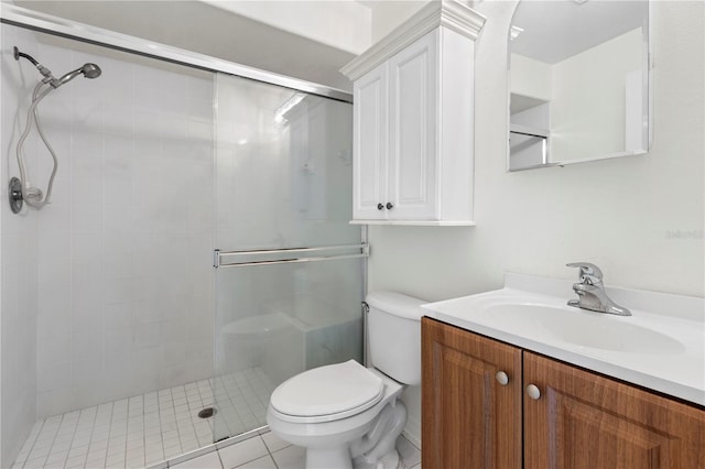 bathroom featuring tile patterned floors, vanity, toilet, and a shower with door