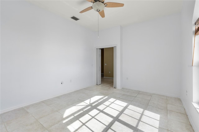 unfurnished room with ceiling fan and light tile patterned floors