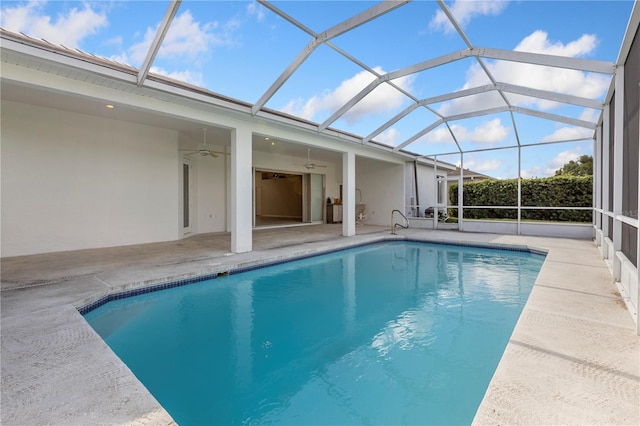 view of pool with a lanai, ceiling fan, and a patio area