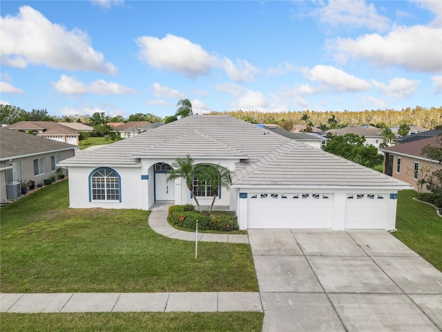 single story home featuring cooling unit, a front yard, and a garage