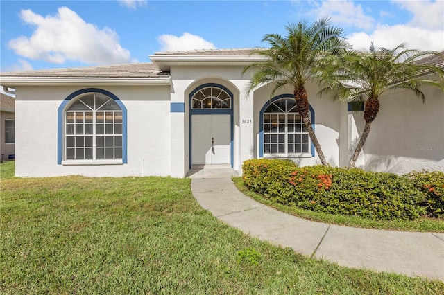 doorway to property with a yard