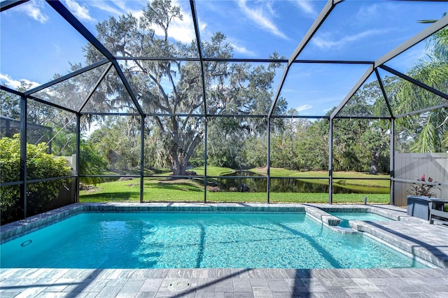 view of swimming pool with glass enclosure, a patio area, a yard, and a water view