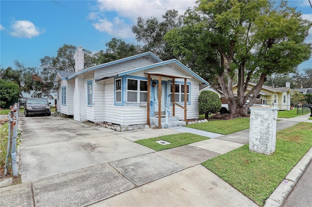 bungalow with a front lawn