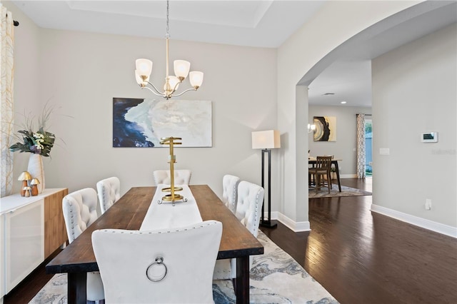 dining room featuring a notable chandelier and dark hardwood / wood-style floors