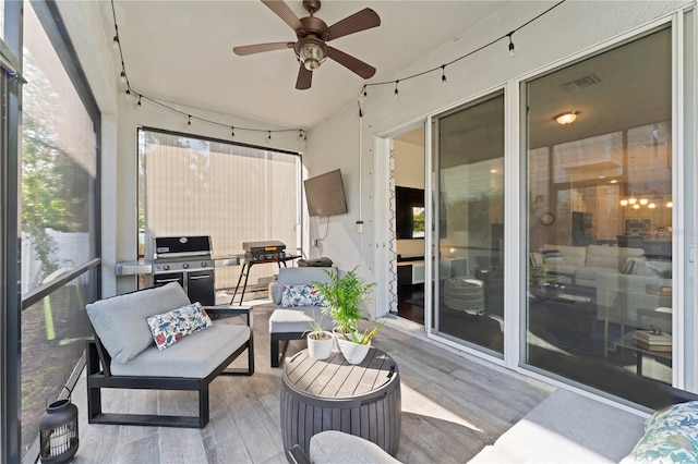 sunroom / solarium featuring ceiling fan