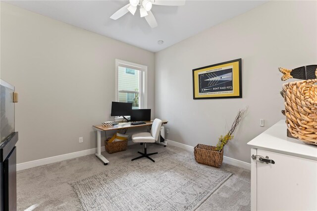 carpeted office featuring ceiling fan