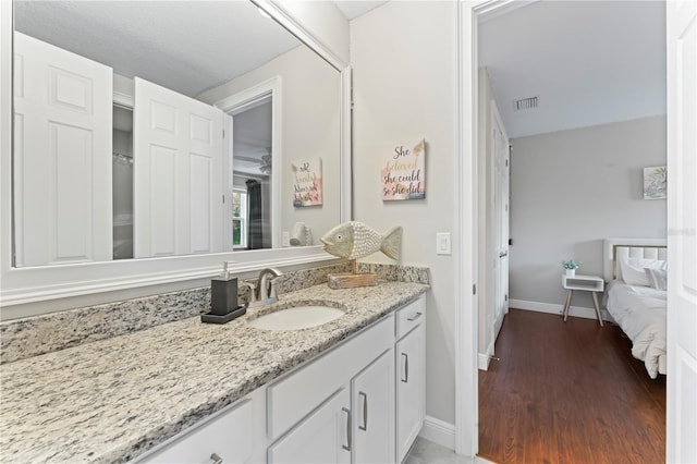 bathroom featuring vanity and hardwood / wood-style floors