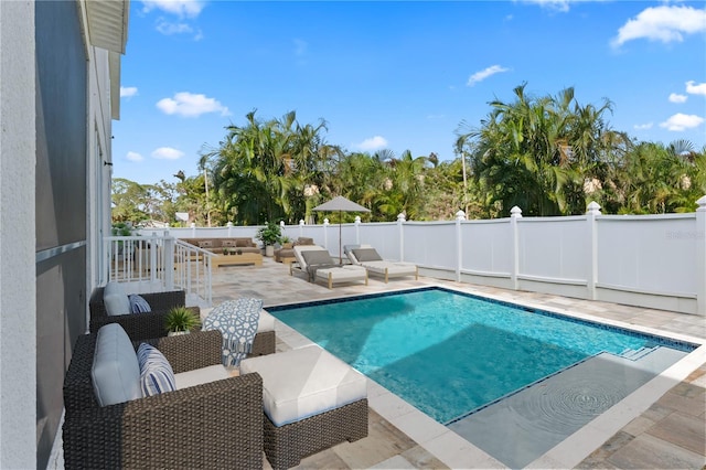 view of swimming pool featuring an outdoor living space and a patio