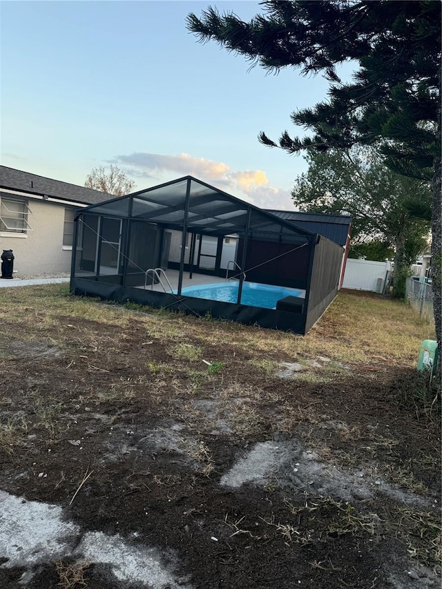 rear view of property featuring a lanai