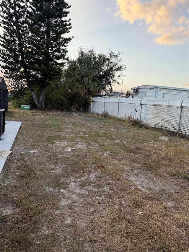 view of yard at dusk