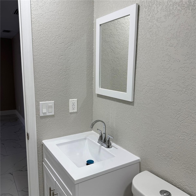 bathroom featuring vanity and toilet