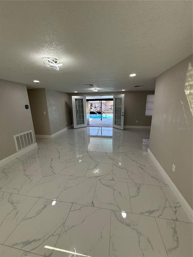 spare room with a textured ceiling