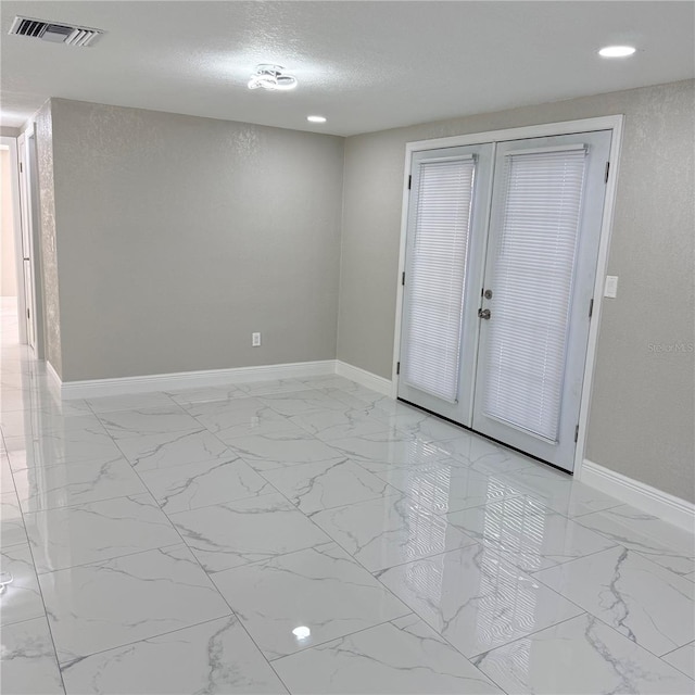 spare room with a textured ceiling