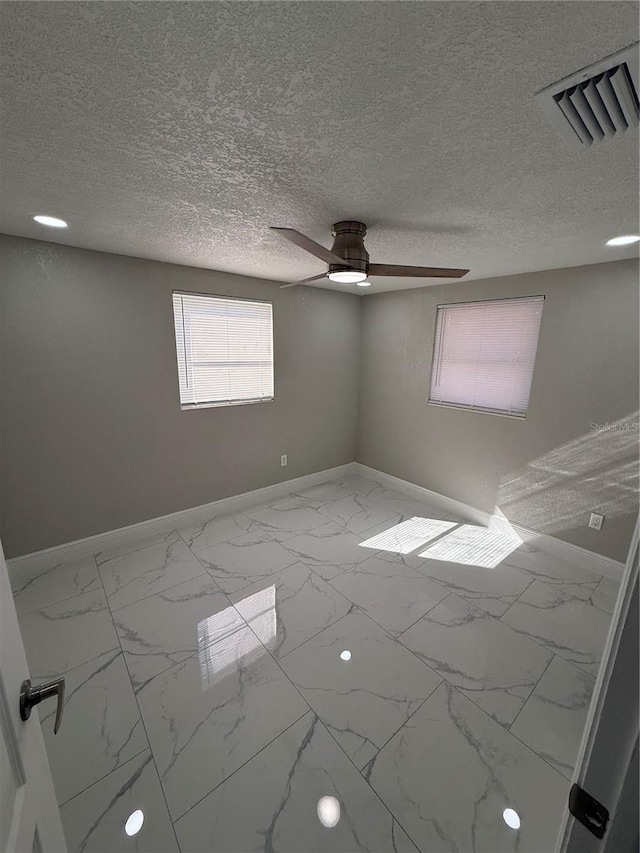 spare room featuring a textured ceiling