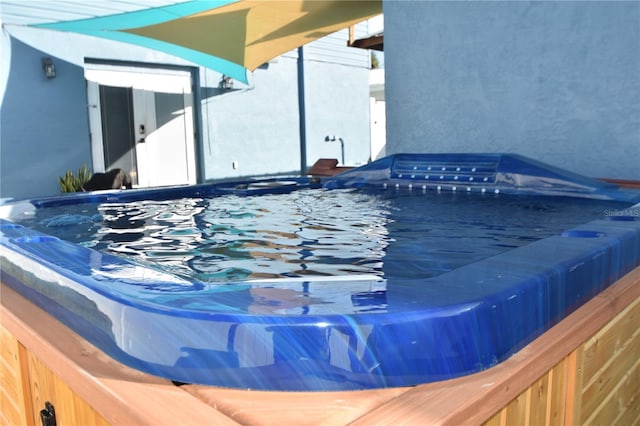 exterior space featuring a pool with hot tub