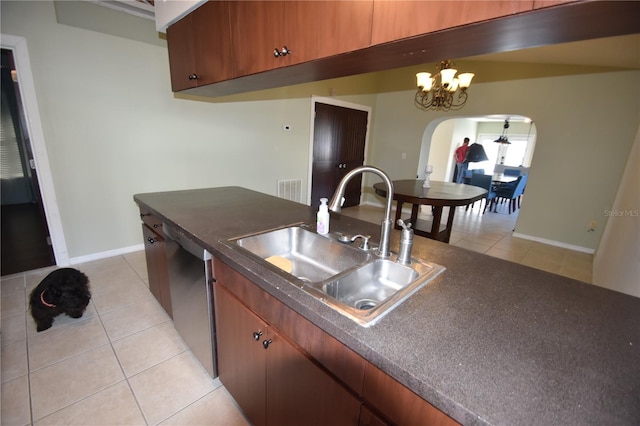 kitchen featuring dishwasher, light tile patterned floors, a chandelier, and sink