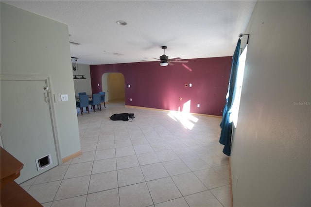 tiled empty room with ceiling fan