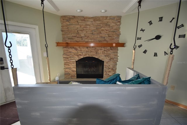 living room with a fireplace and tile patterned flooring