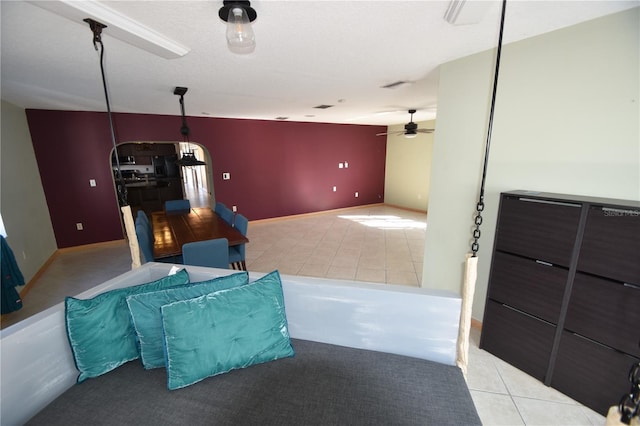 interior space featuring ceiling fan and light tile patterned flooring