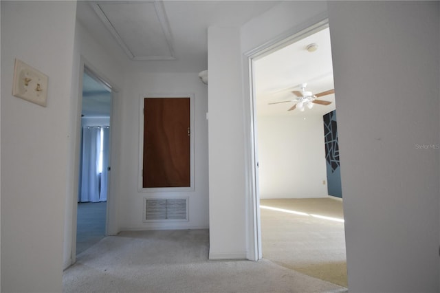 hallway with light colored carpet