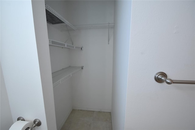 walk in closet featuring light tile patterned floors