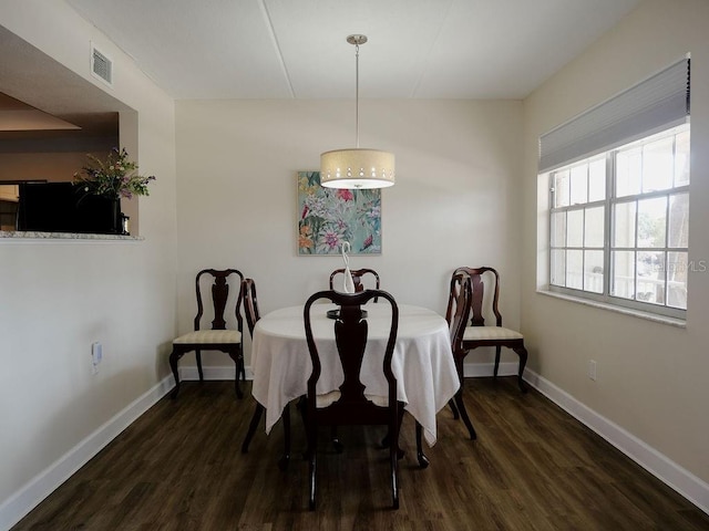 dining area with dark hardwood / wood-style floors