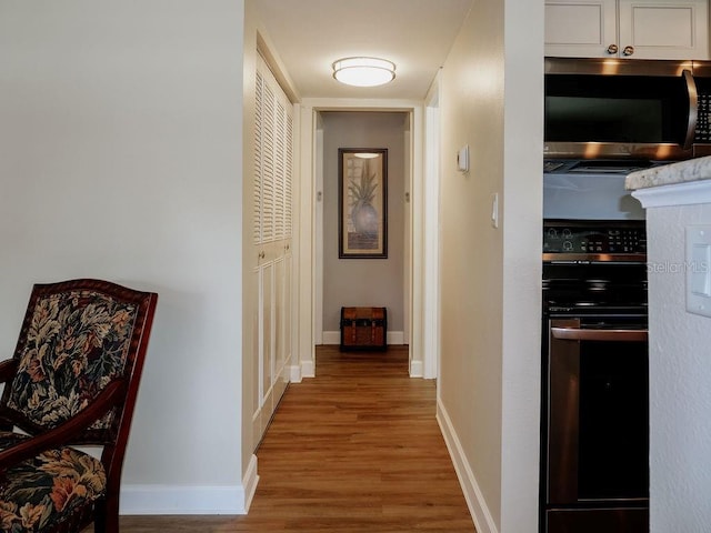 hall with wood-type flooring