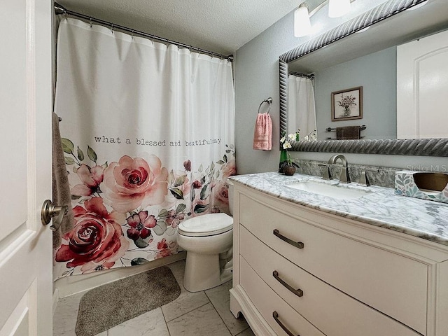 bathroom with toilet, vanity, and a textured ceiling