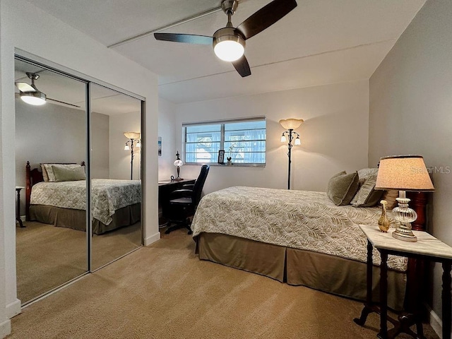 carpeted bedroom with ceiling fan and a closet