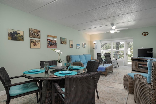 dining space with ceiling fan and a textured ceiling