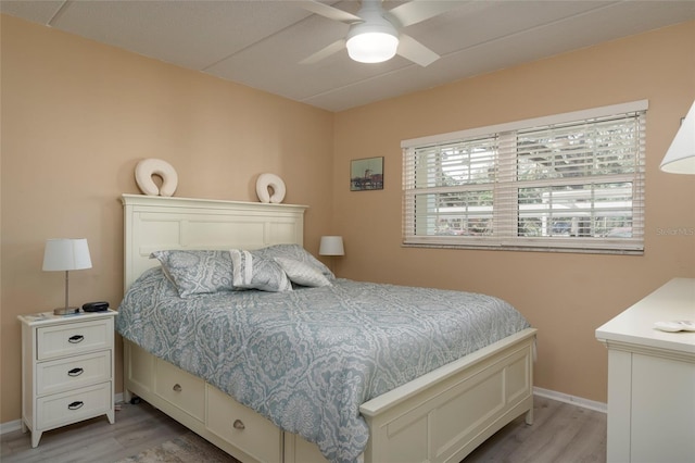 bedroom with ceiling fan and light hardwood / wood-style flooring