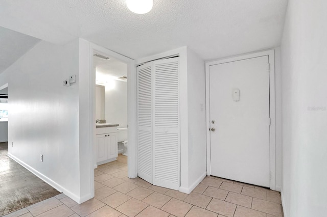 554 Fairways Cir Unit A, Ocala, FL 34472 - entryway with a textured ceiling, light tile patterned floors, and baseboards
