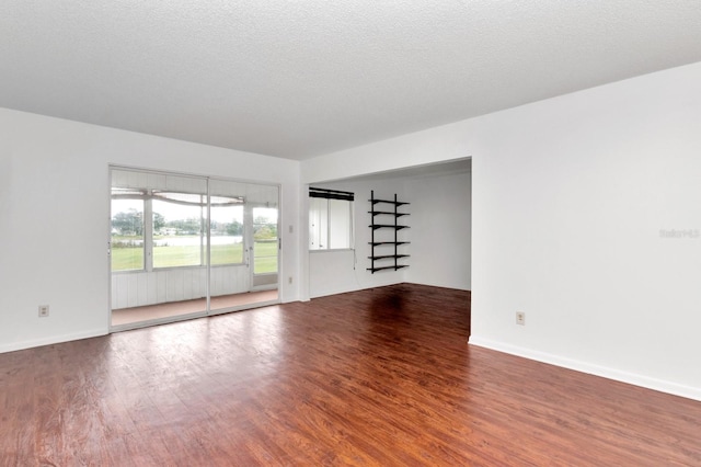 spare room with hardwood / wood-style floors and a textured ceiling