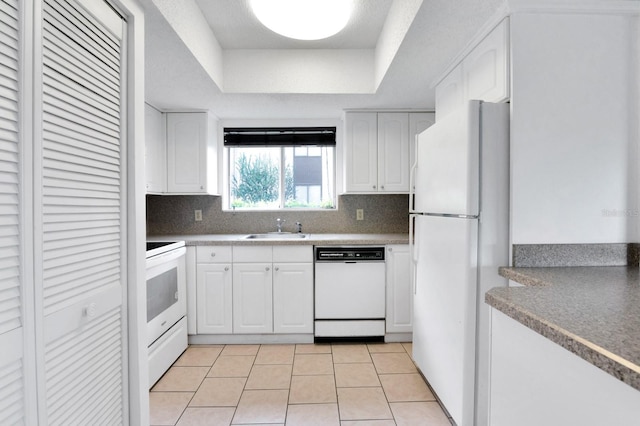 kitchen featuring white cabinets, sink, tasteful backsplash, a raised ceiling, and white appliances