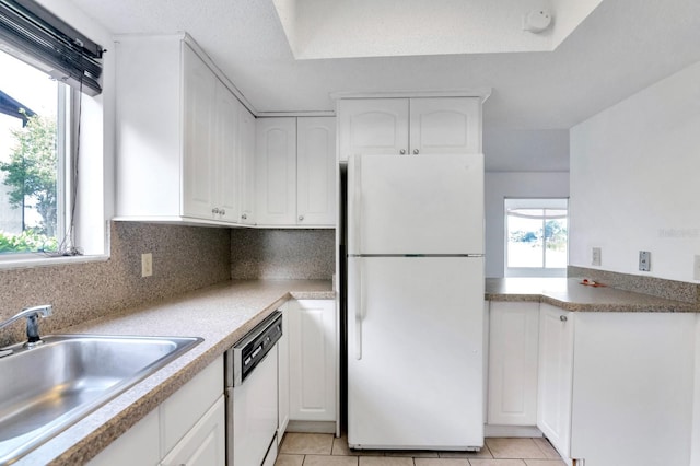 kitchen with white cabinets, white appliances, sink, and plenty of natural light