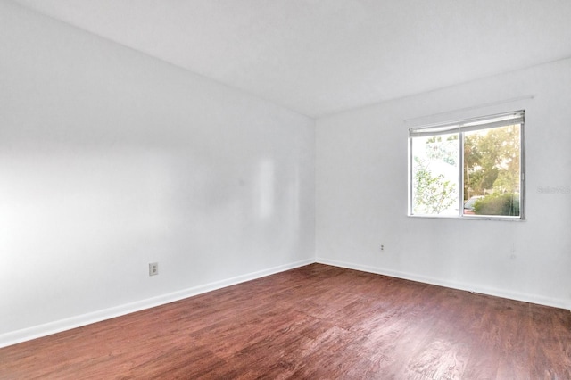 unfurnished room featuring dark wood-type flooring