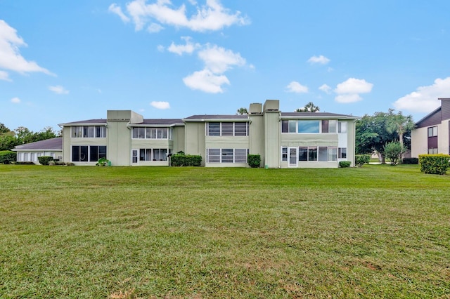 554 Fairways Cir Unit A, Ocala, FL 34472 - rear view of house with a lawn and stucco siding