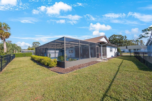 back of property featuring a lawn and a lanai