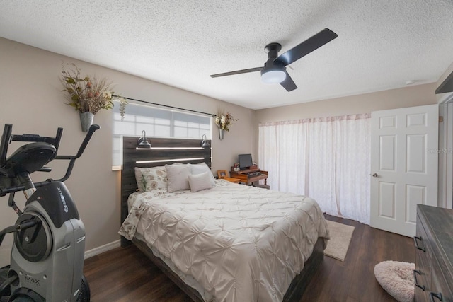 bedroom featuring dark hardwood / wood-style flooring, a textured ceiling, and ceiling fan