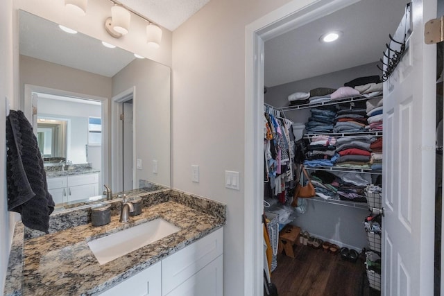 bathroom featuring vanity, hardwood / wood-style floors, and a textured ceiling