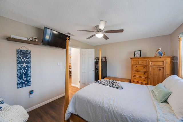 bedroom featuring dark hardwood / wood-style flooring, a textured ceiling, and ceiling fan