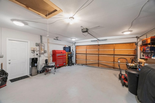 garage with a garage door opener and electric panel