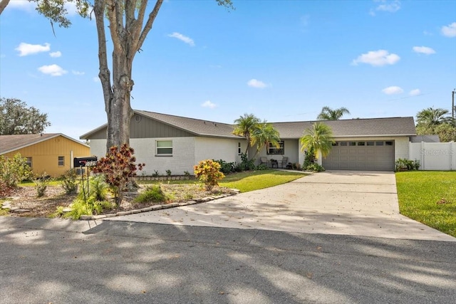 ranch-style house with a garage and a front lawn