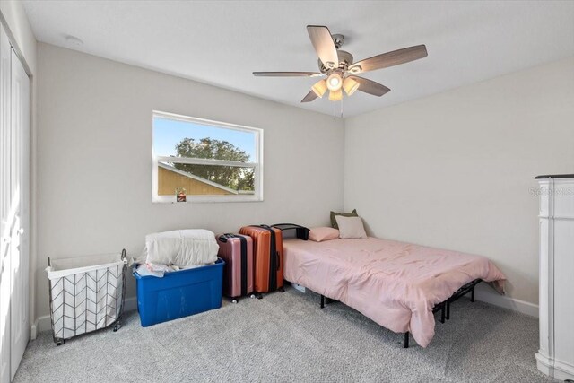 bedroom featuring a closet, light carpet, and ceiling fan