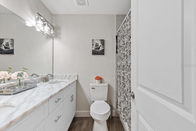 bathroom with vanity, hardwood / wood-style flooring, and toilet