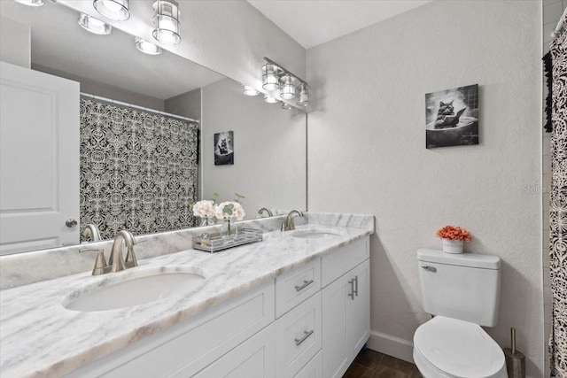 bathroom featuring toilet, vanity, and hardwood / wood-style floors