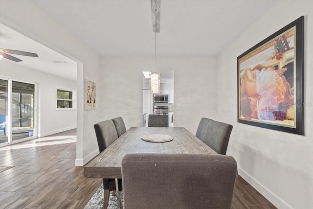 dining area with ceiling fan and dark hardwood / wood-style floors