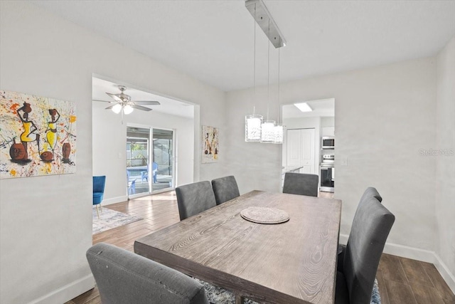 dining area featuring hardwood / wood-style floors and ceiling fan